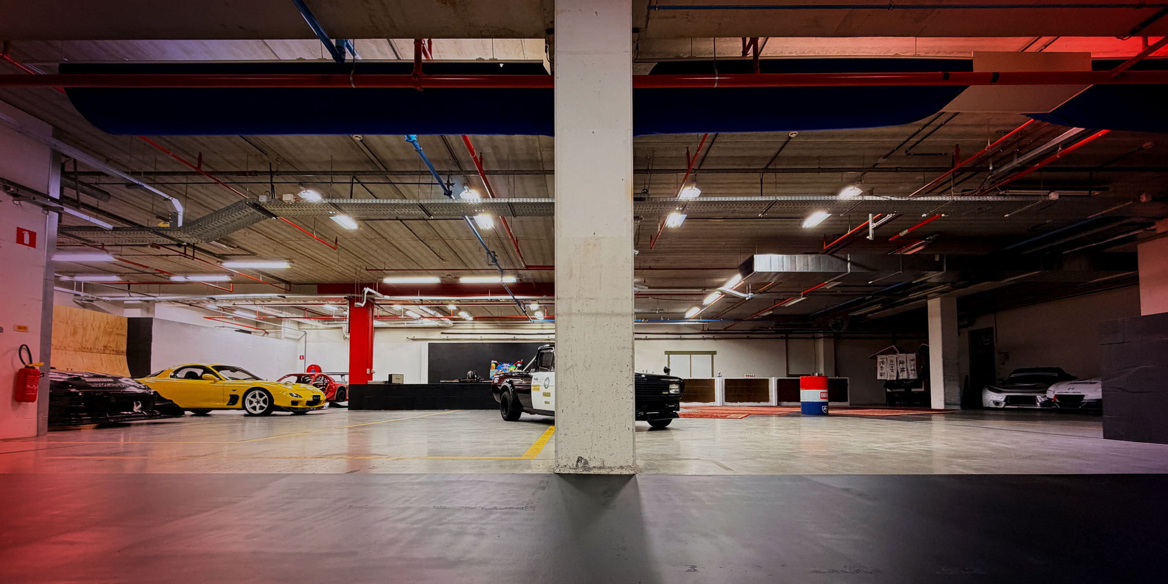 Wide view of The Garage by Gisèle Racing automotive event space near Brussels