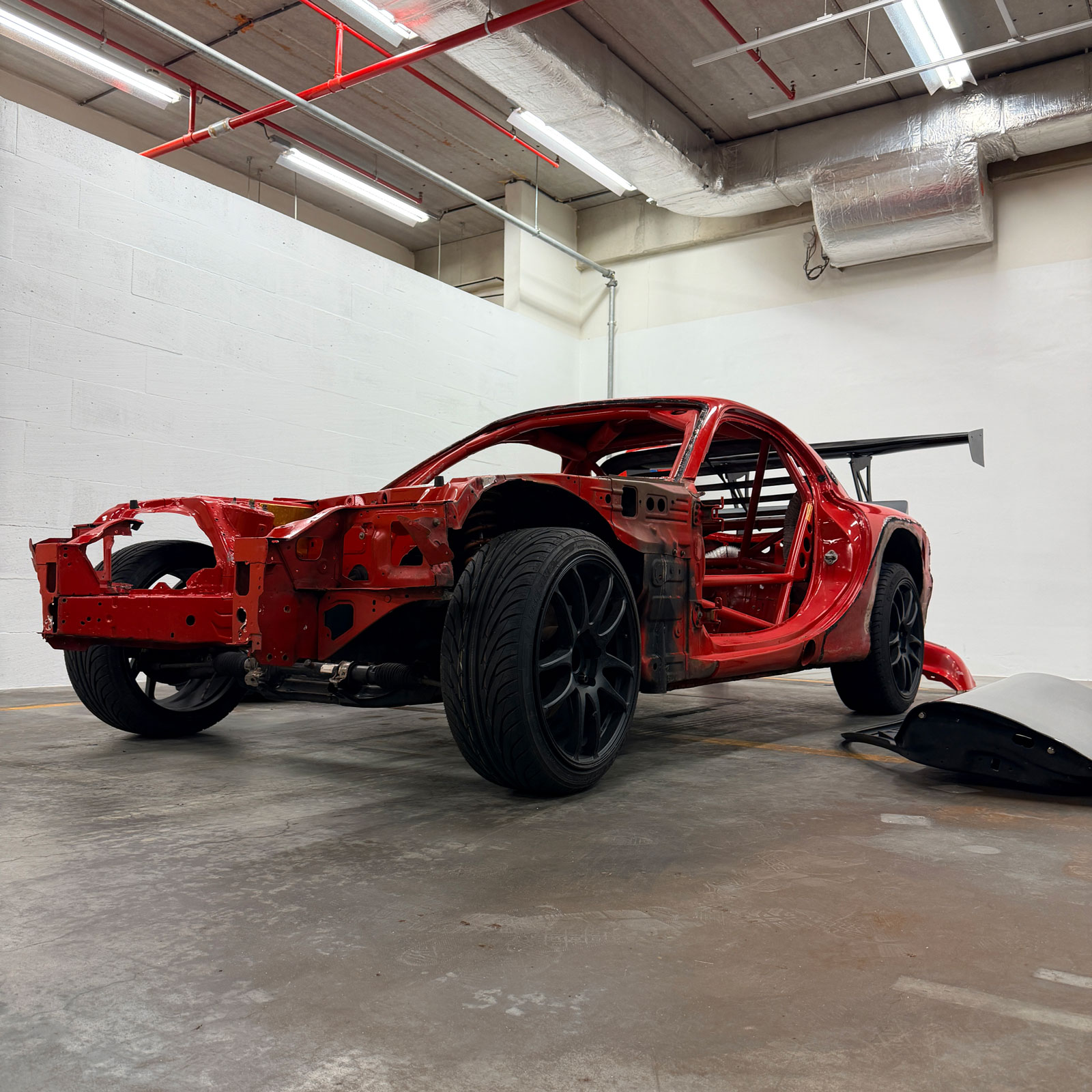 Cars and setup detail inside The Garage by Gisèle Racing